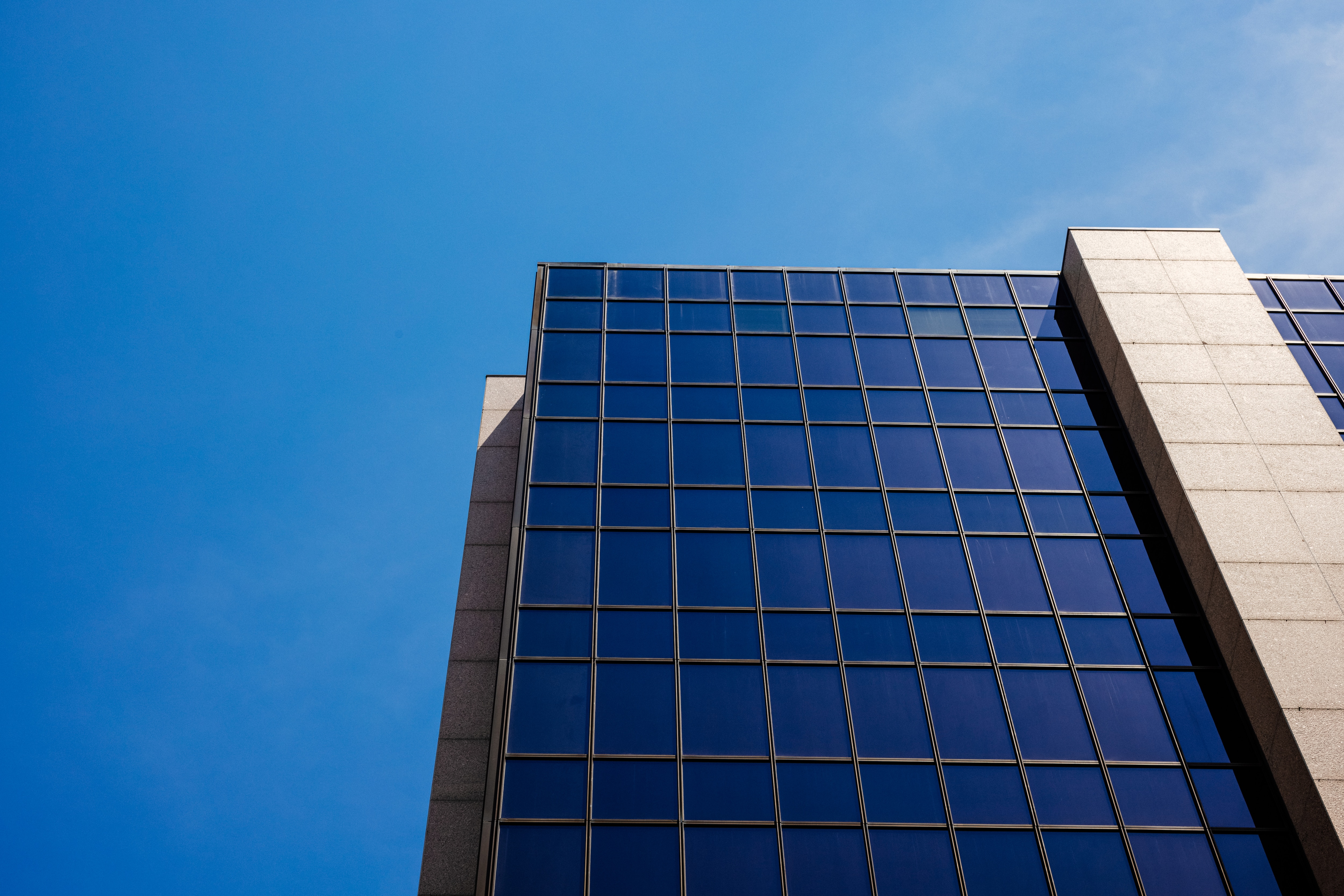 The Hilton Building at Mayo Clinic in Rochester, Minnesota, looking up from below against a blue sky.
